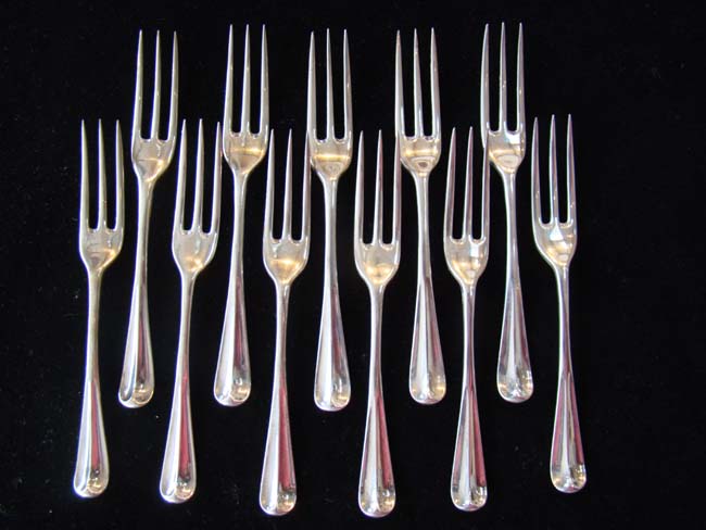 A fine and RARE set of eleven IRISH three-pronged sterling silver dessert forks by Michael Hewitson of Dublin circa 1725-1750